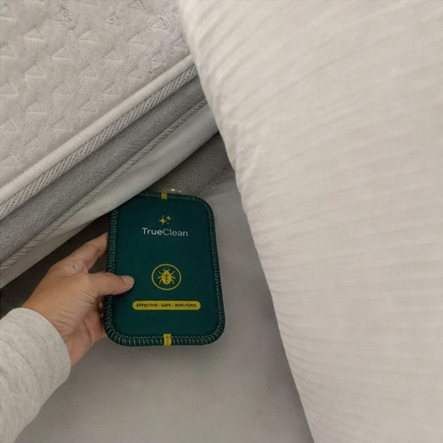UGC review photo placing a CaptureCard near a pillow and mattress edge