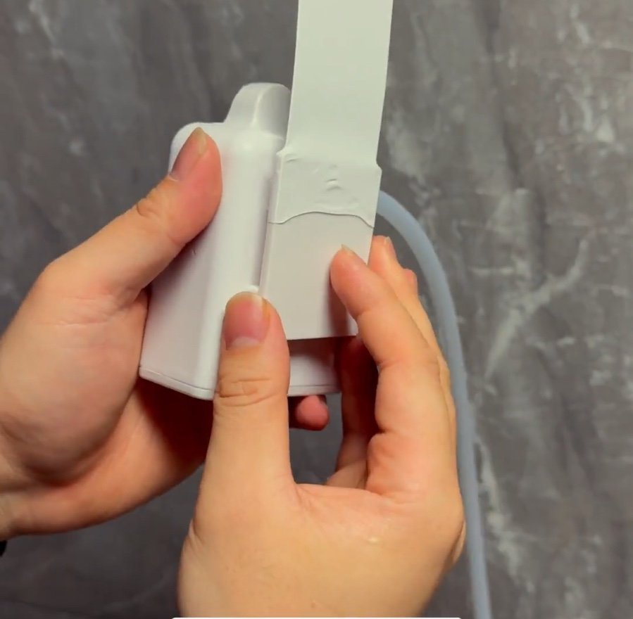 Snapping the clip into the back of the dispenser