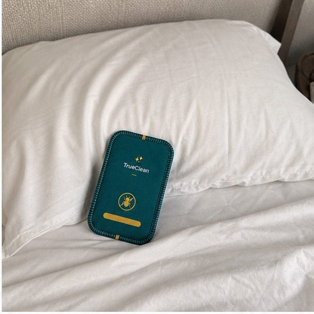 CaptureCards placed near a pillow on white sheets