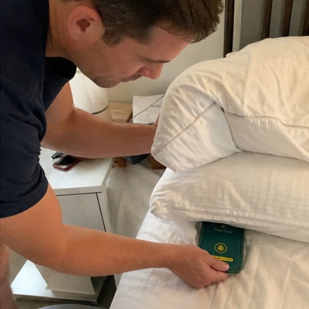 Customer placing CaptureCards by a pillow