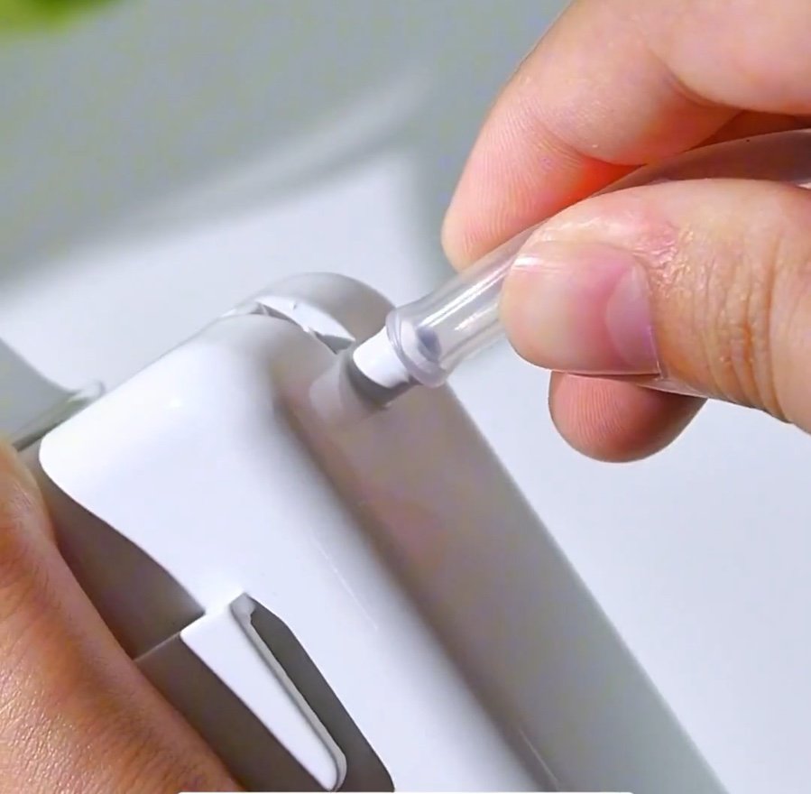 Pushing the single tube onto the top of the dispenser